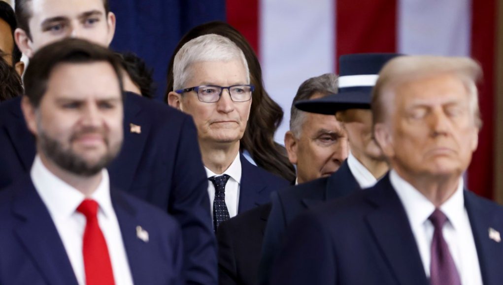 Apple CEO Tim Cook (C) seen behind US President Donald Trump (R) and US Vice President JD Vance (L) after the two were sworn into office at an inauguration ceremony in the rotunda of the United States Capitol on January 20, 2025 in Washington, DC.